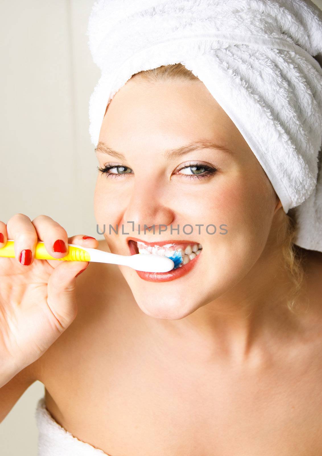 happy woman brushing teeth by lanak