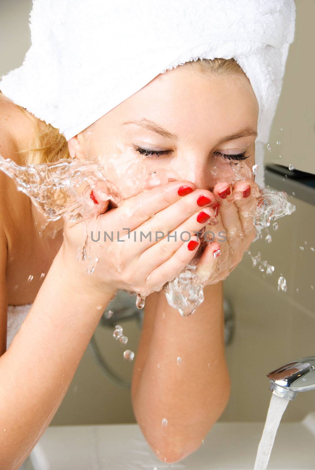 beautiful girl washing her face by lanak