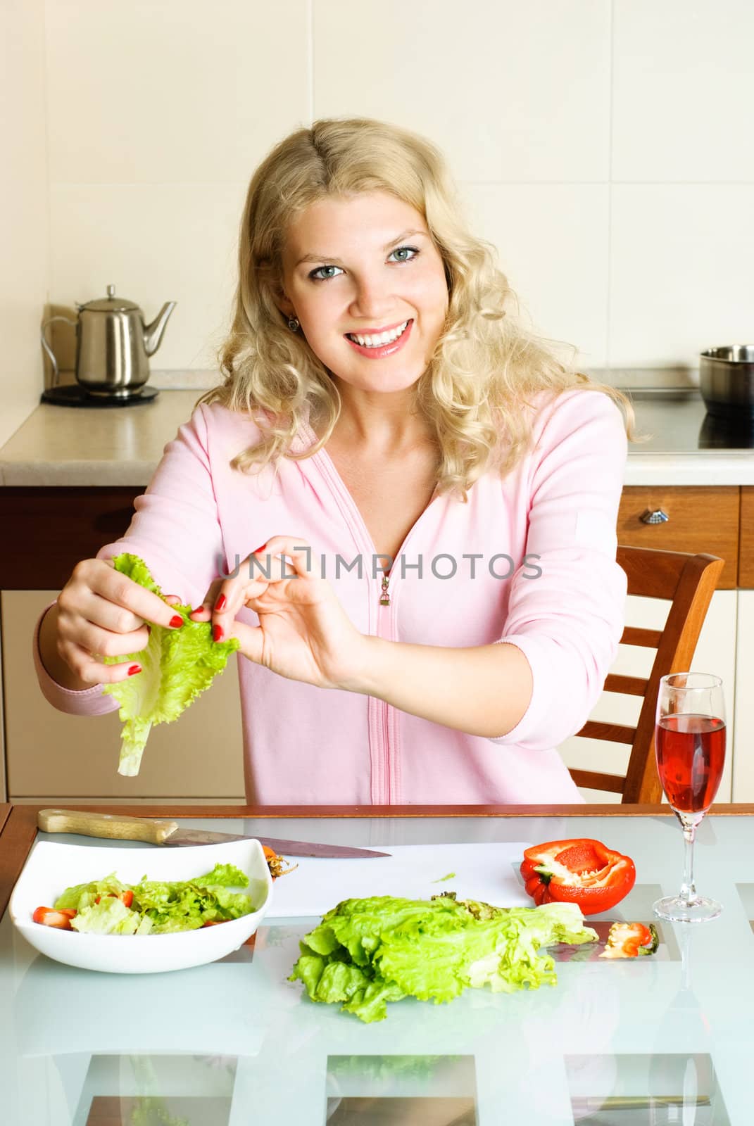 pretty woman making salad by lanak