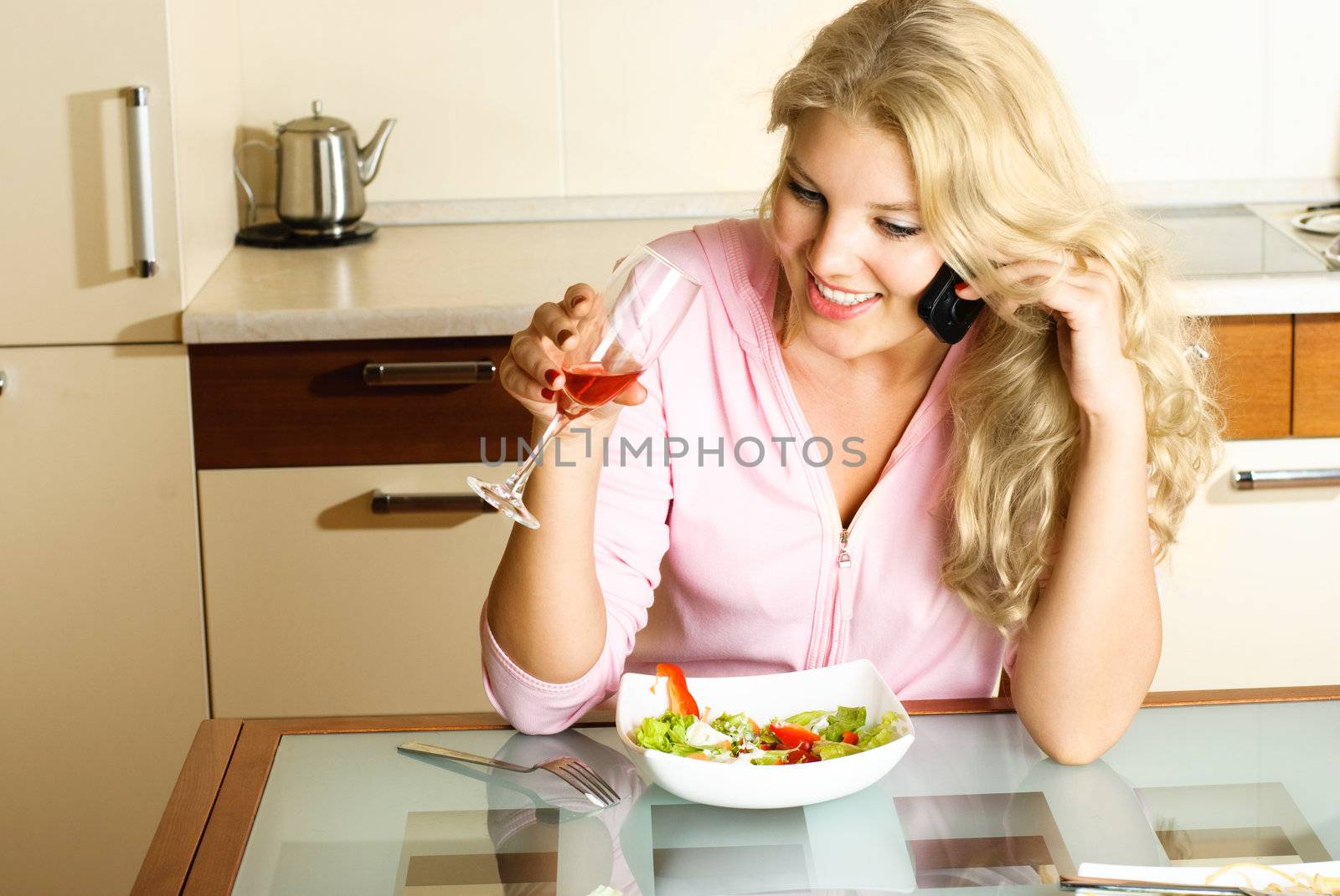 pretty girl eating and taking on the cellphone by lanak