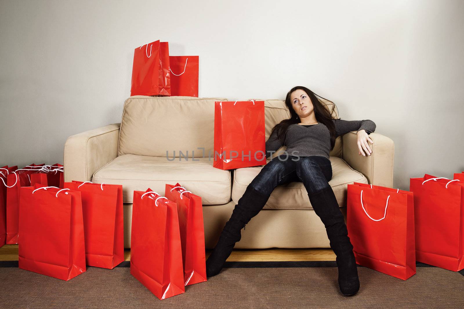 A female in her 20's resting from a long shopping day.
