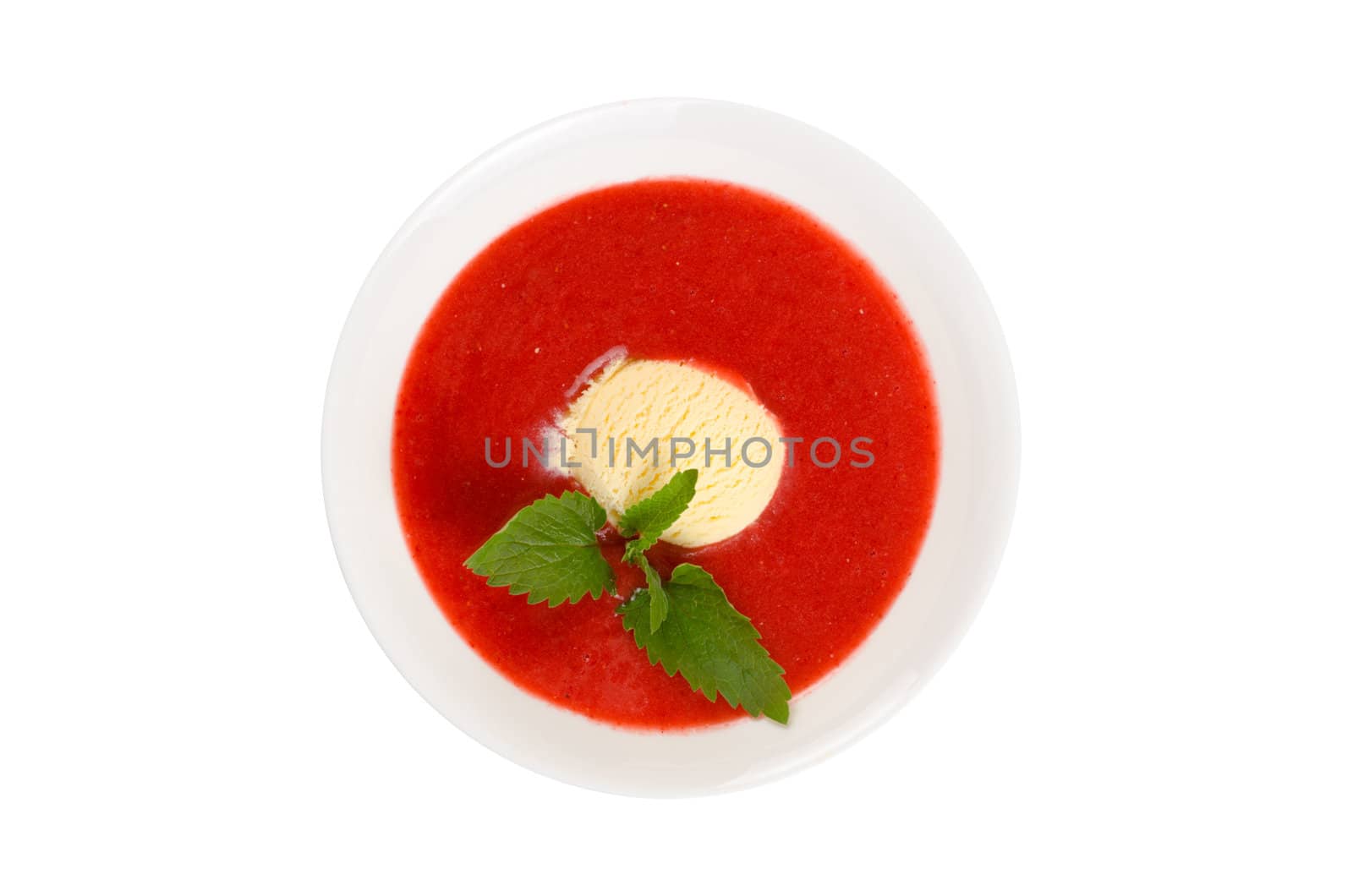 Strawberry soup with ice cream and mint on a white