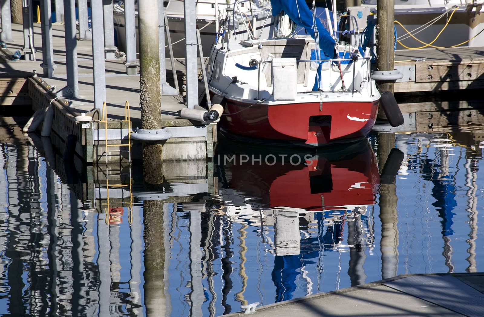 Reflections of boats, water, pier, dock, Edmond Washington  Trademarks removed.