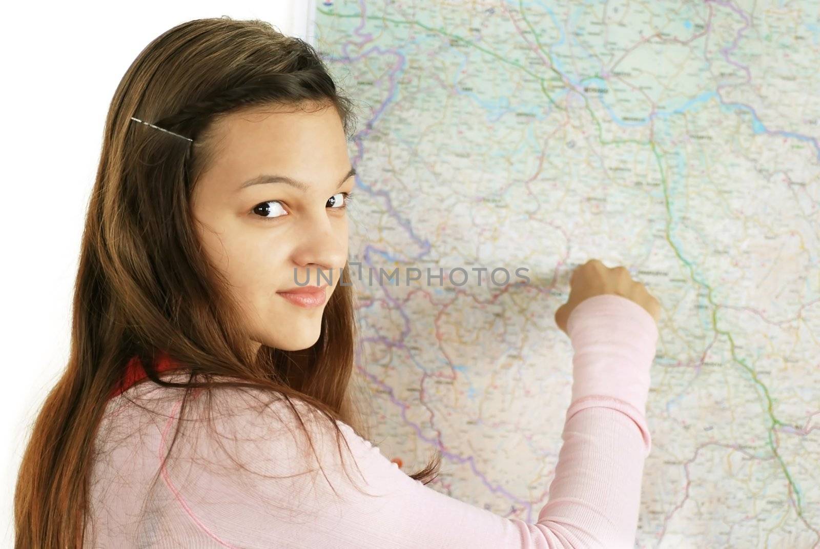 happy caucasian longhaired teenage girl pointing at map