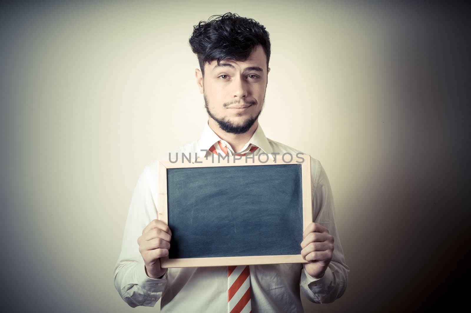 businessman with a blank blackboard on gray background