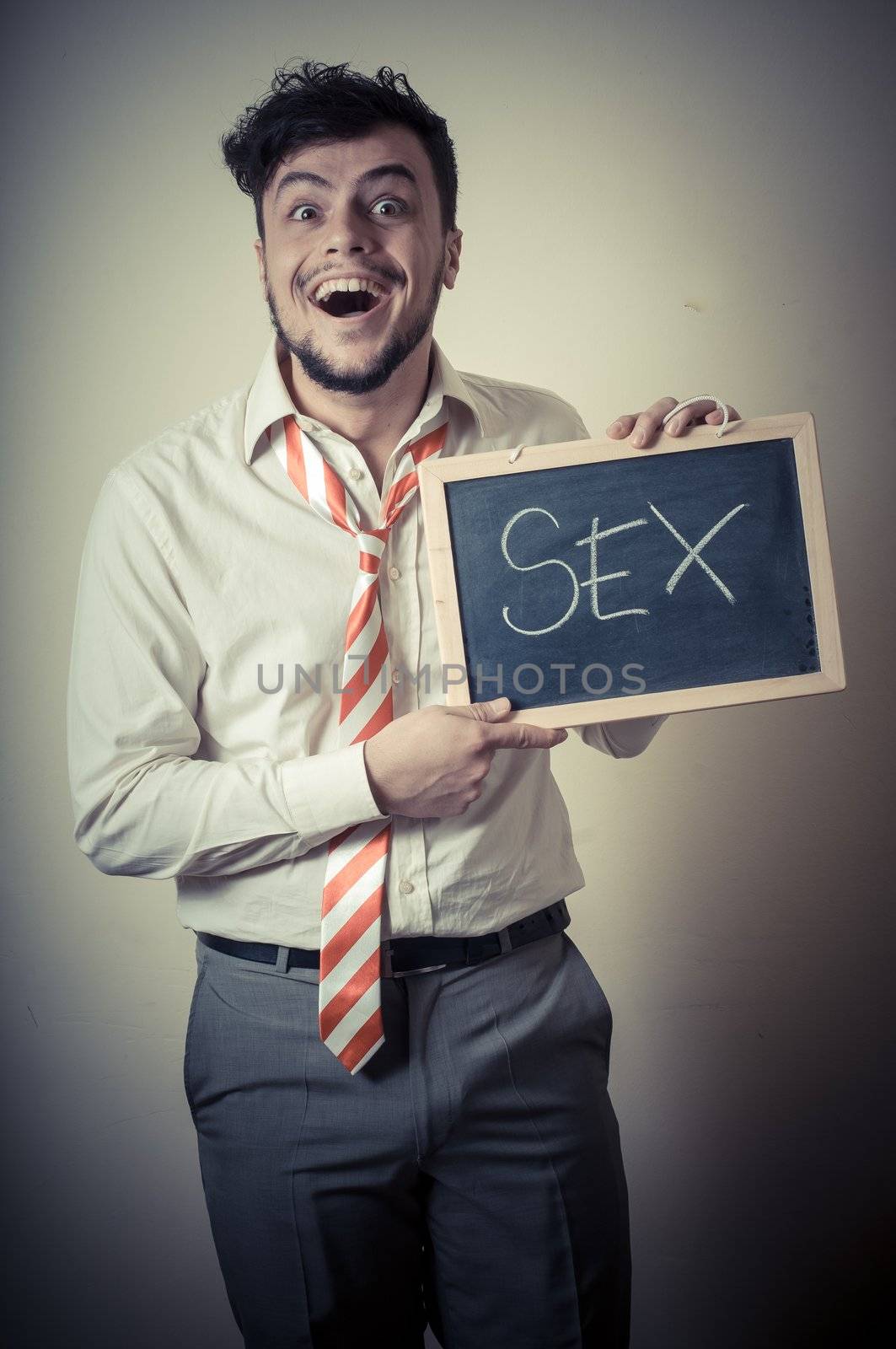 businessman with a blank blackboard write sex on gray background