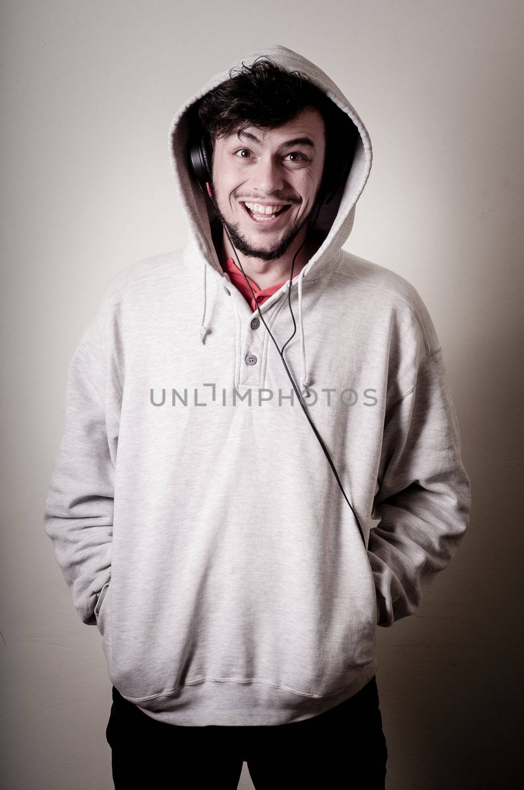 boy with sweatshirt and headphones on gray background 