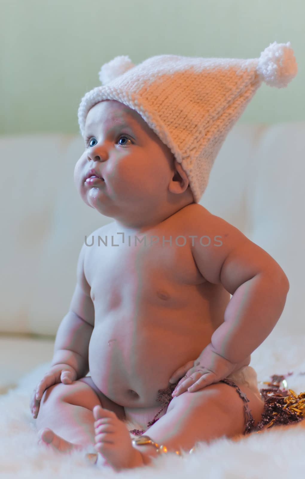 Portrait of baby in hat looking left