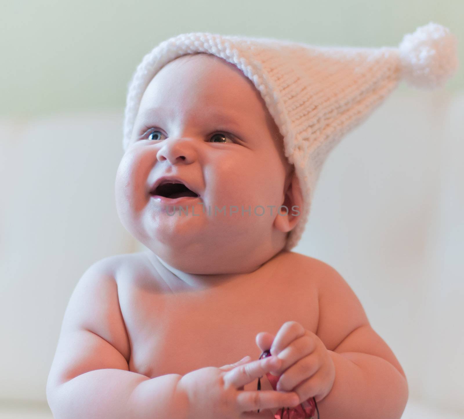 Portrait of smiling baby in white hat