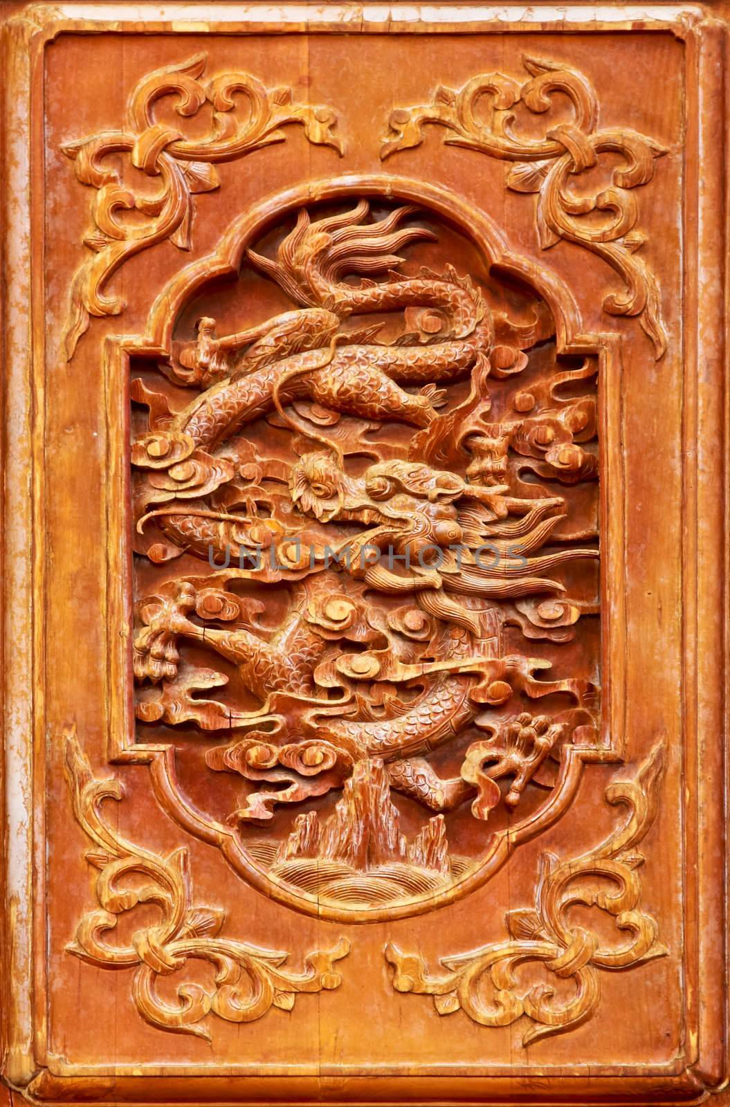 Dragon design on the wooden door of Chinese temple