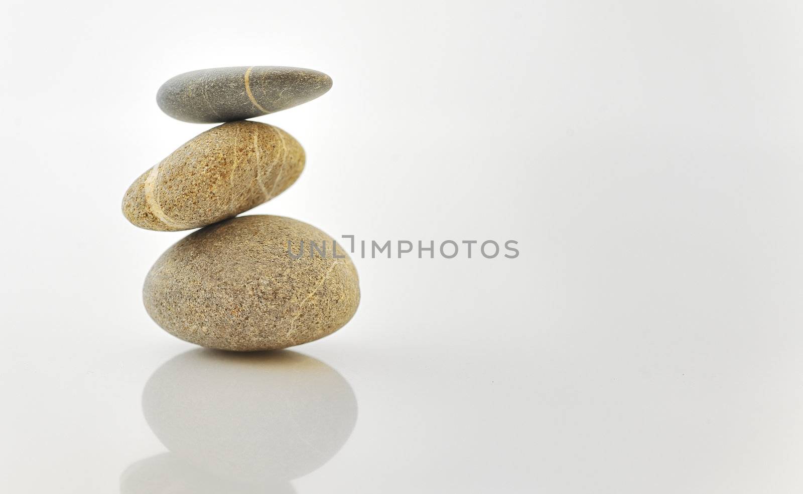 Pyramid of stones over white.