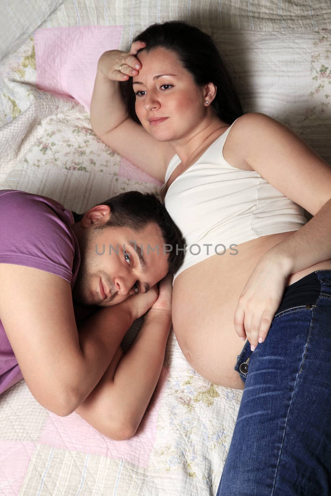 Portrait of a happy pregnant woman and of her husband at home