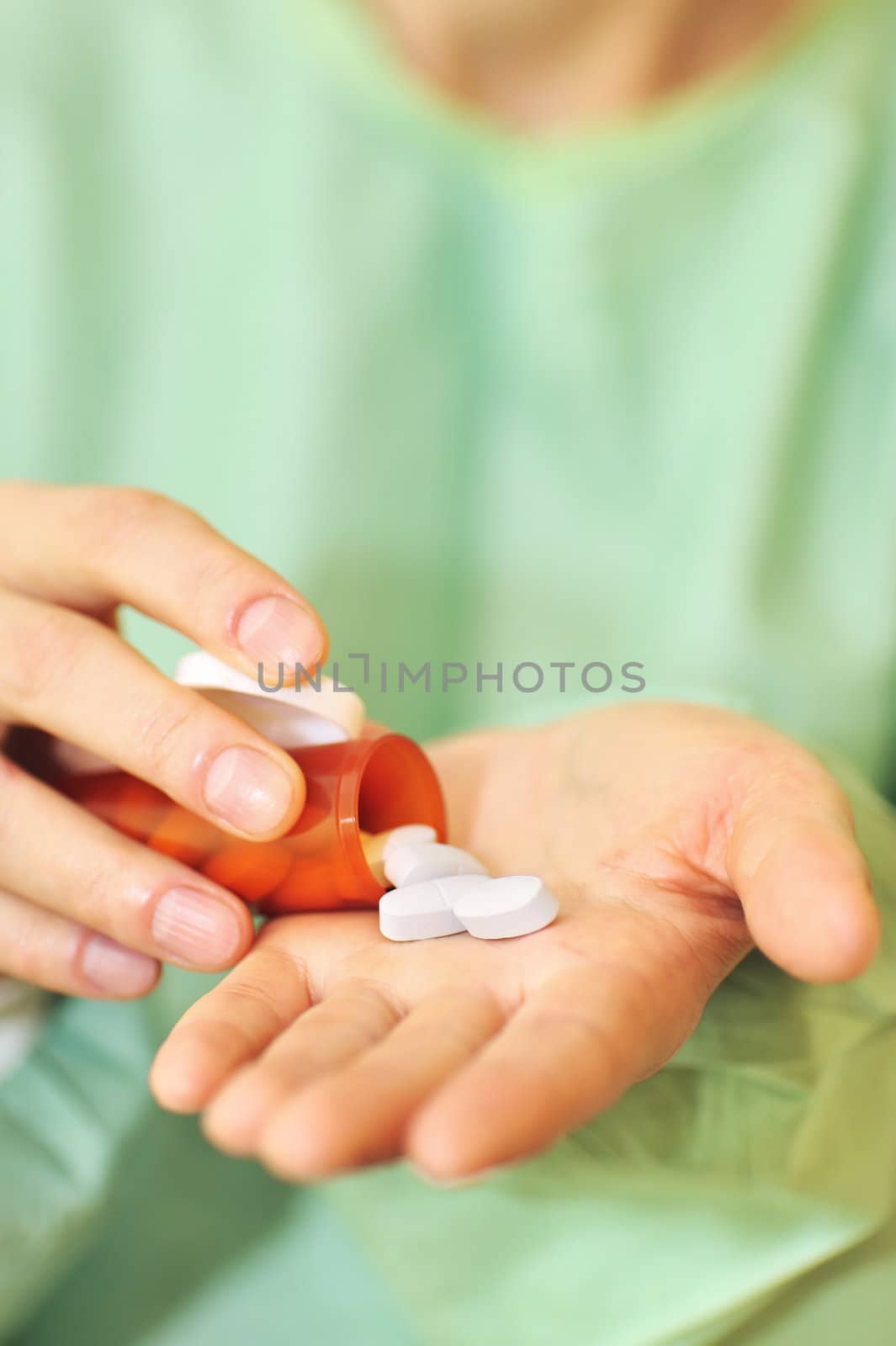 doctor holding bottle of prescription pills