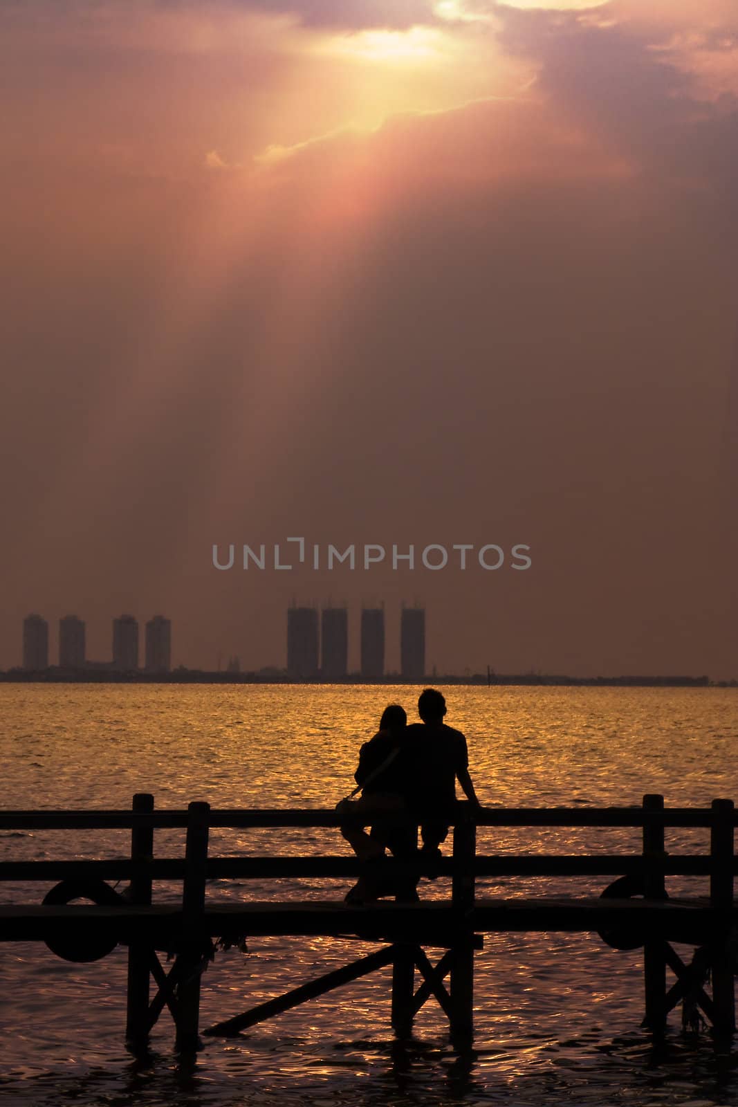Couple Enjoying Romantic Sunset by tfjunction