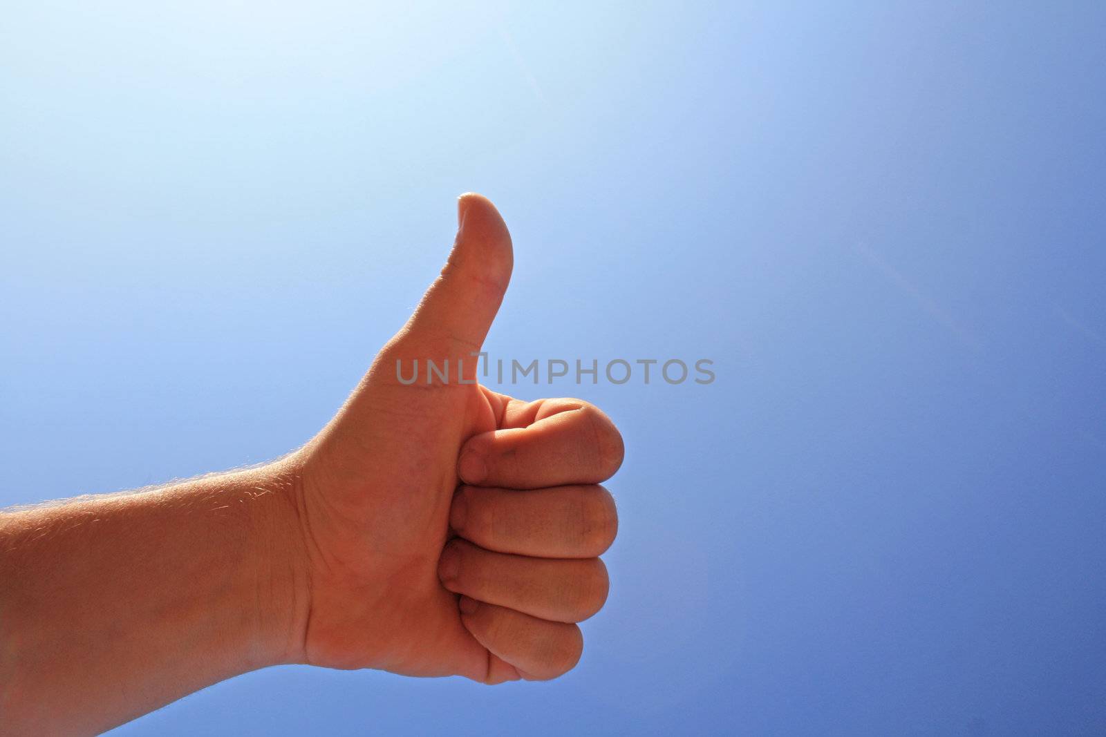 men's hand make thumbs up on blue sky