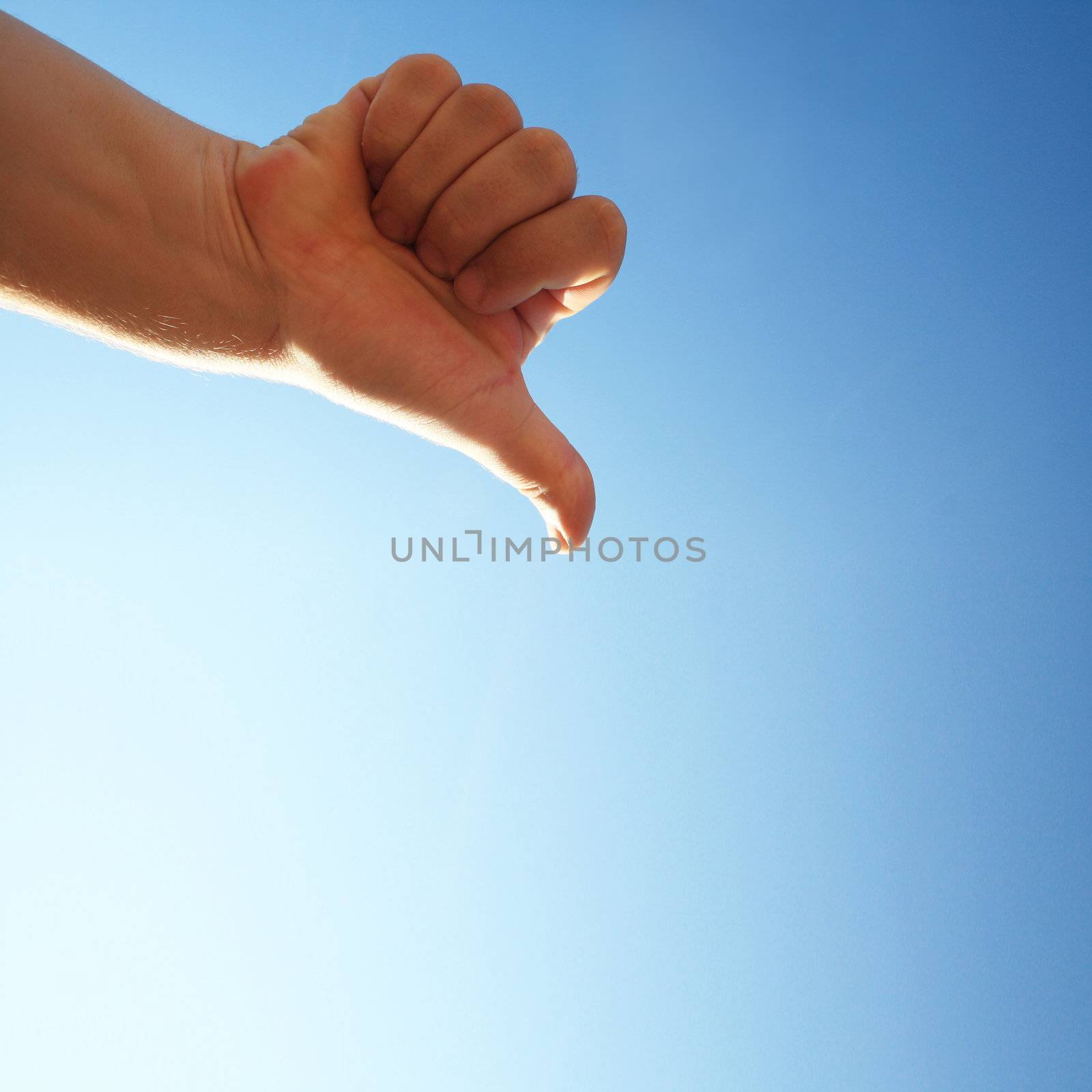 thumbs down on a blue background by photochecker