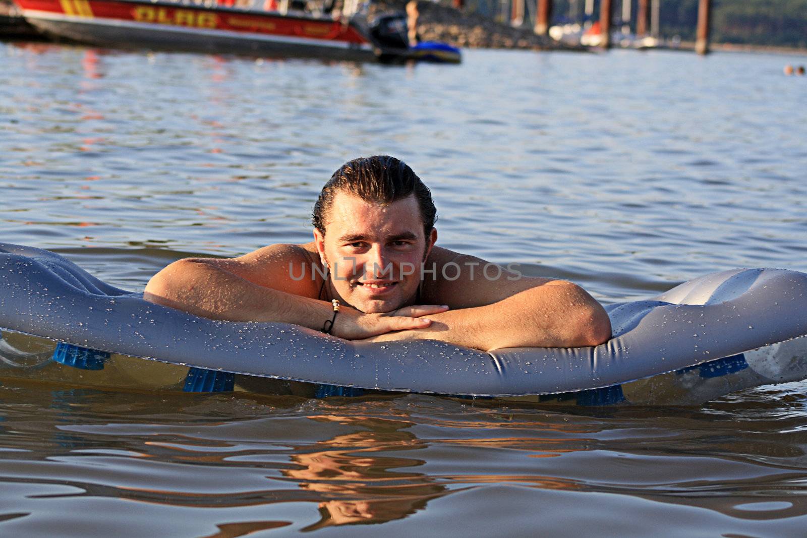 man on the inflatable beach mattress  