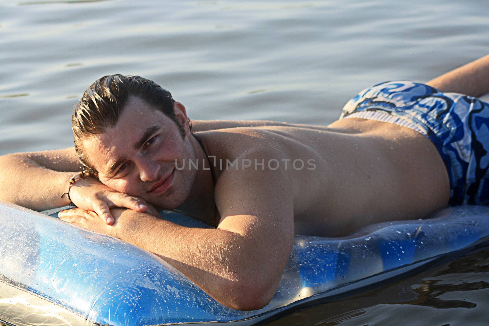 man on the inflatable beach mattress  