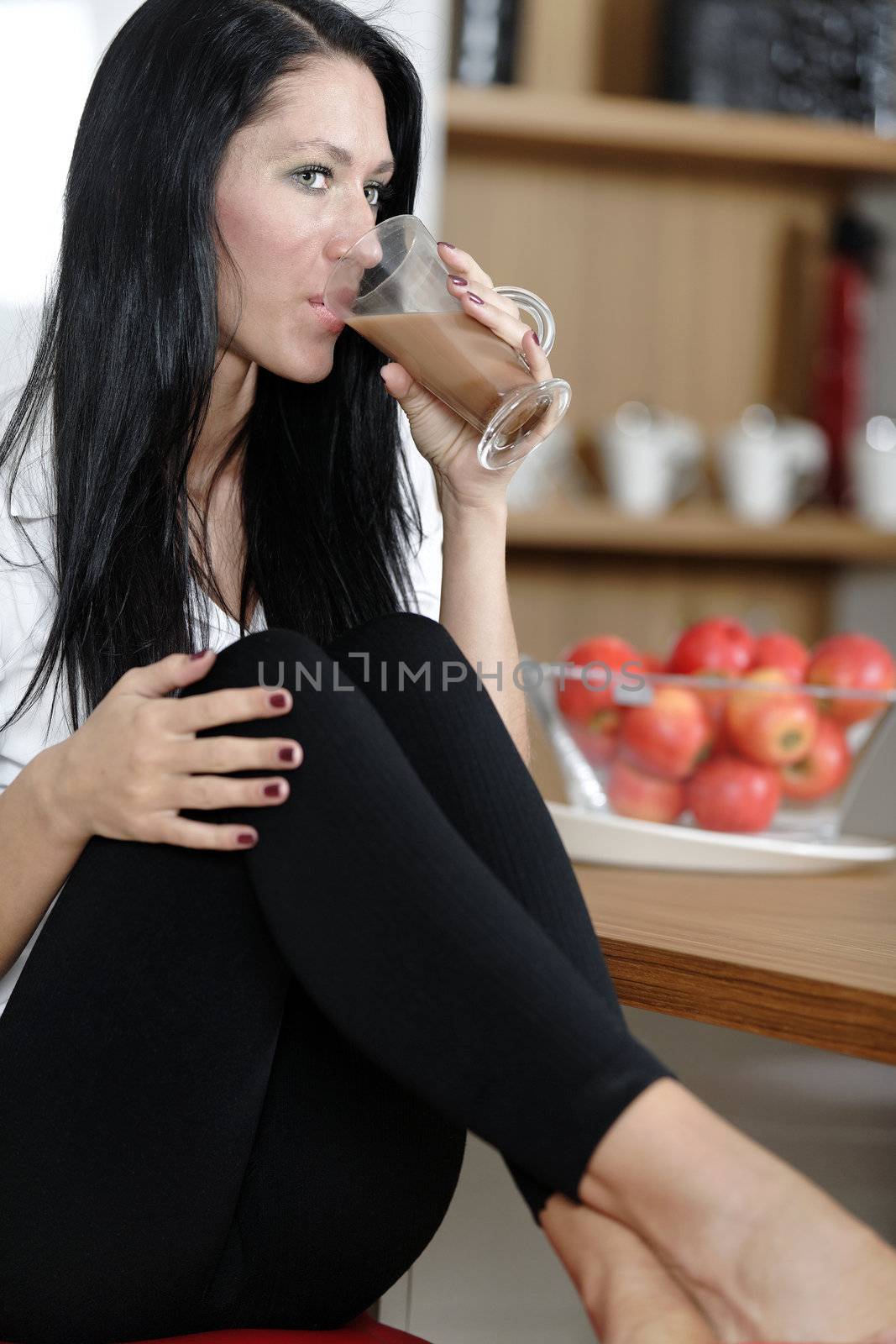 Woman taking a coffee break by studiofi