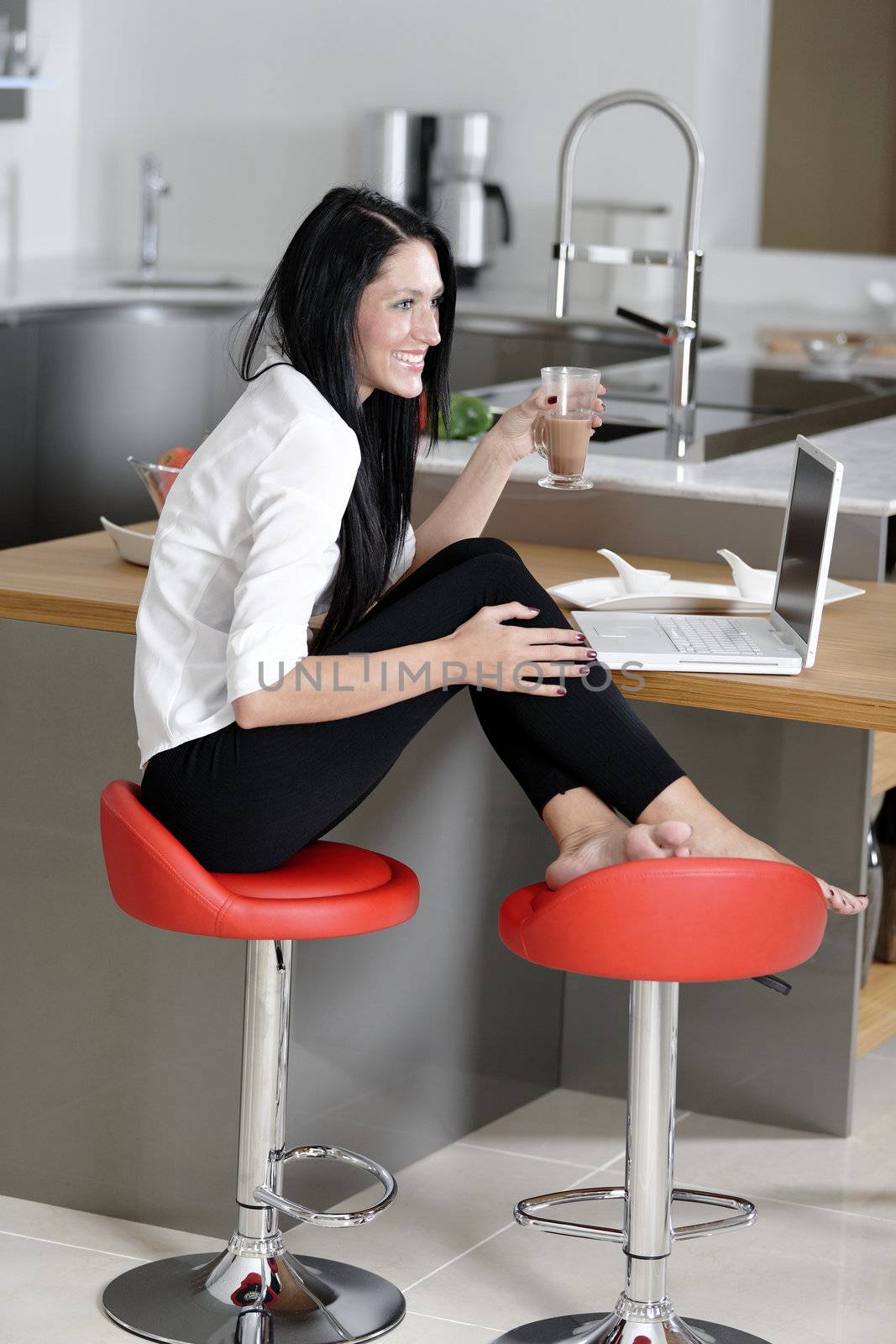 Woman taking a coffee break by studiofi