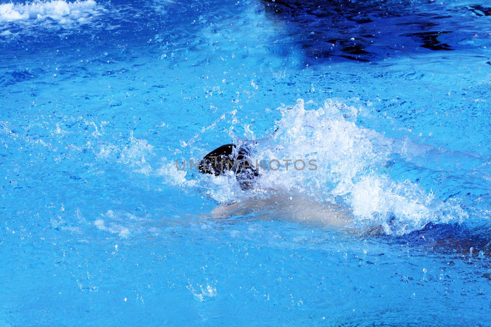 man swims in swimming pool