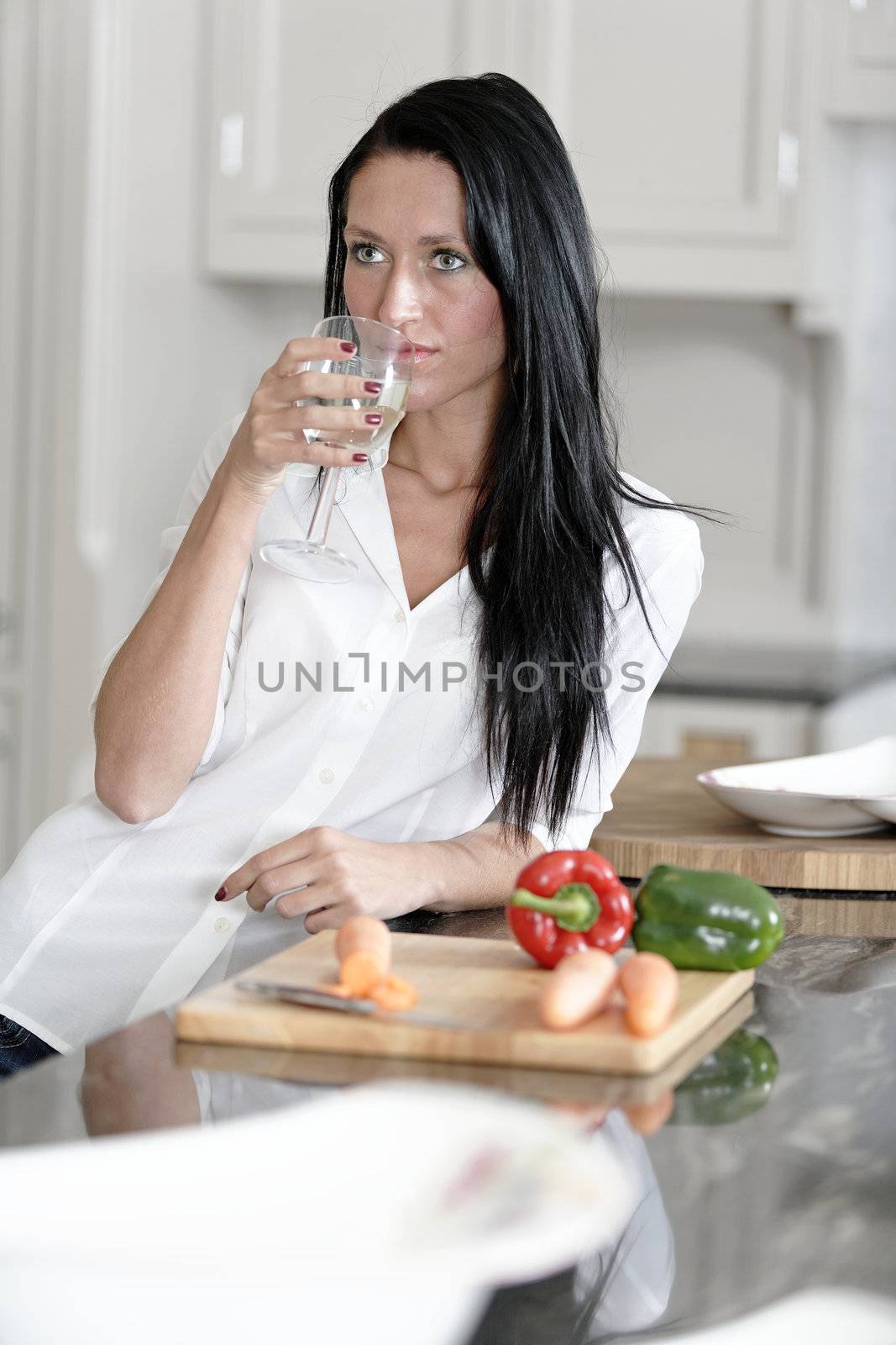 Woman preparing a meal in the kitchen by studiofi