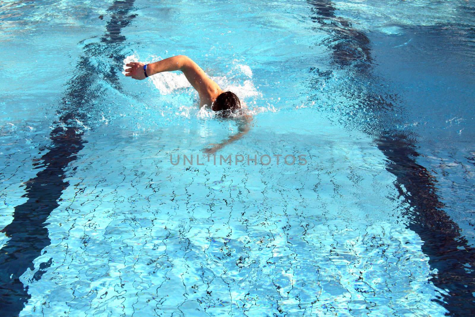 man swims in swimming pool