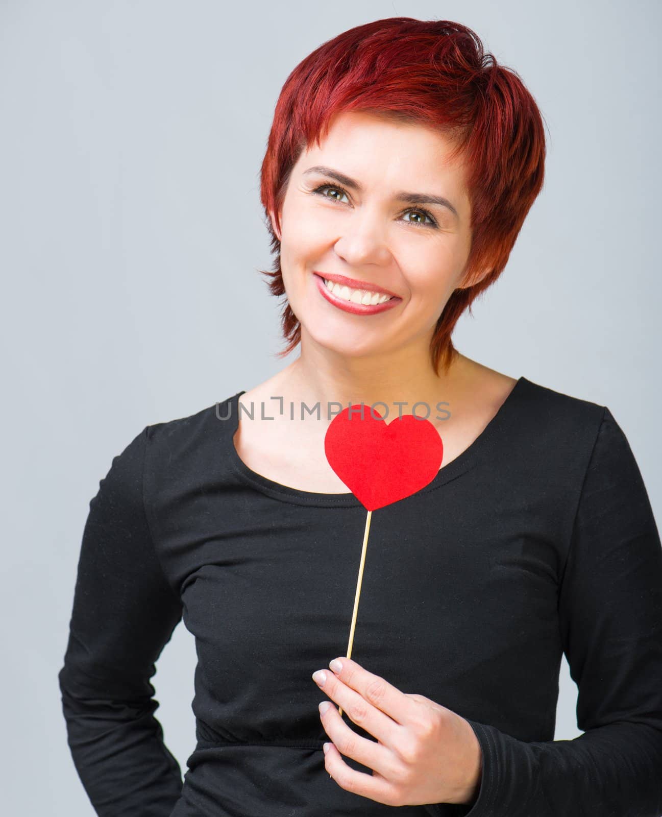 beautiful young woman with a red paper heart