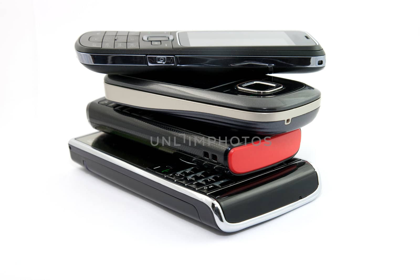 Pile of Several Modern Mobile Phones PDA Cell Handheld Units Isolated on White Background