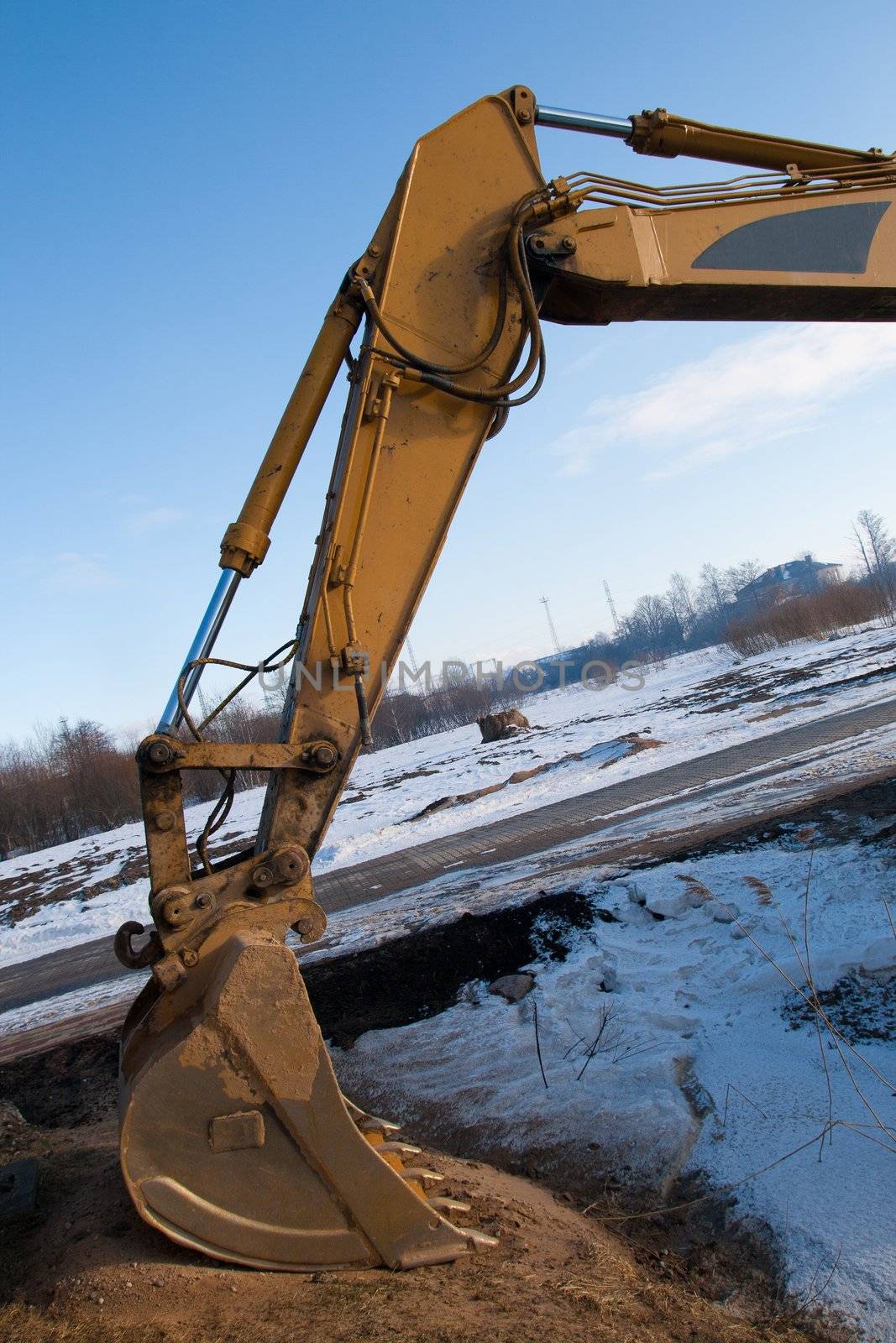 Steel bucket of an earth excavator standing idle
