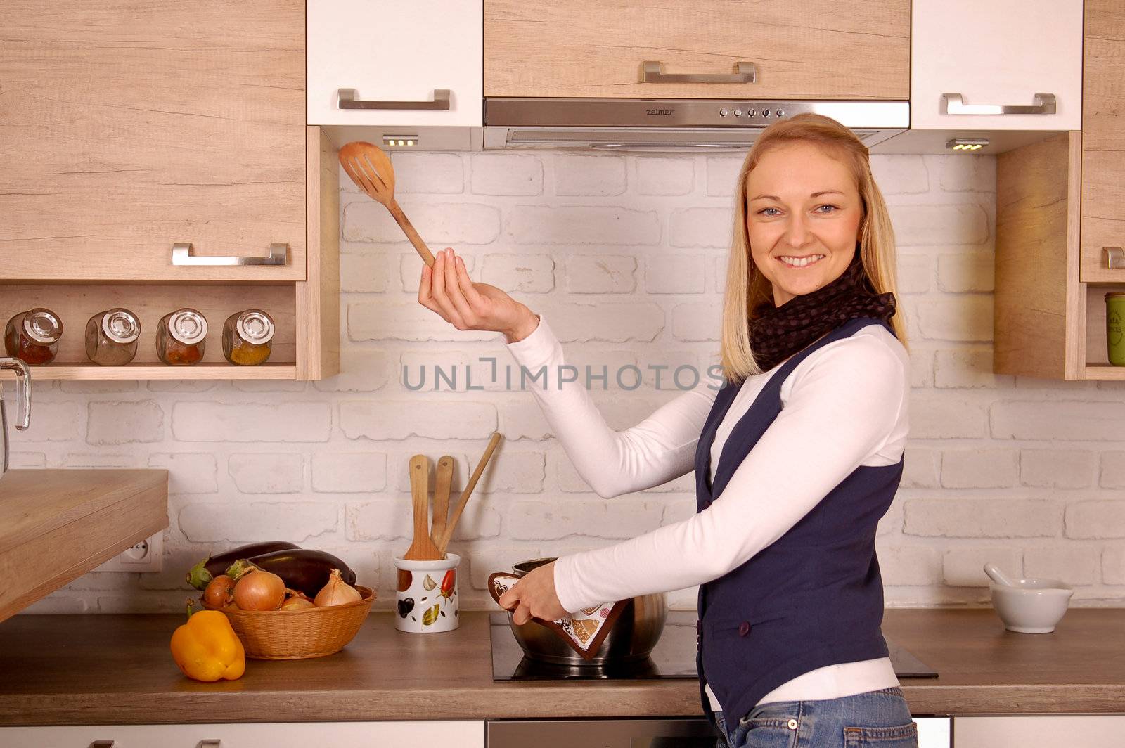 Young woman cooking dinner in a rustic kitchen