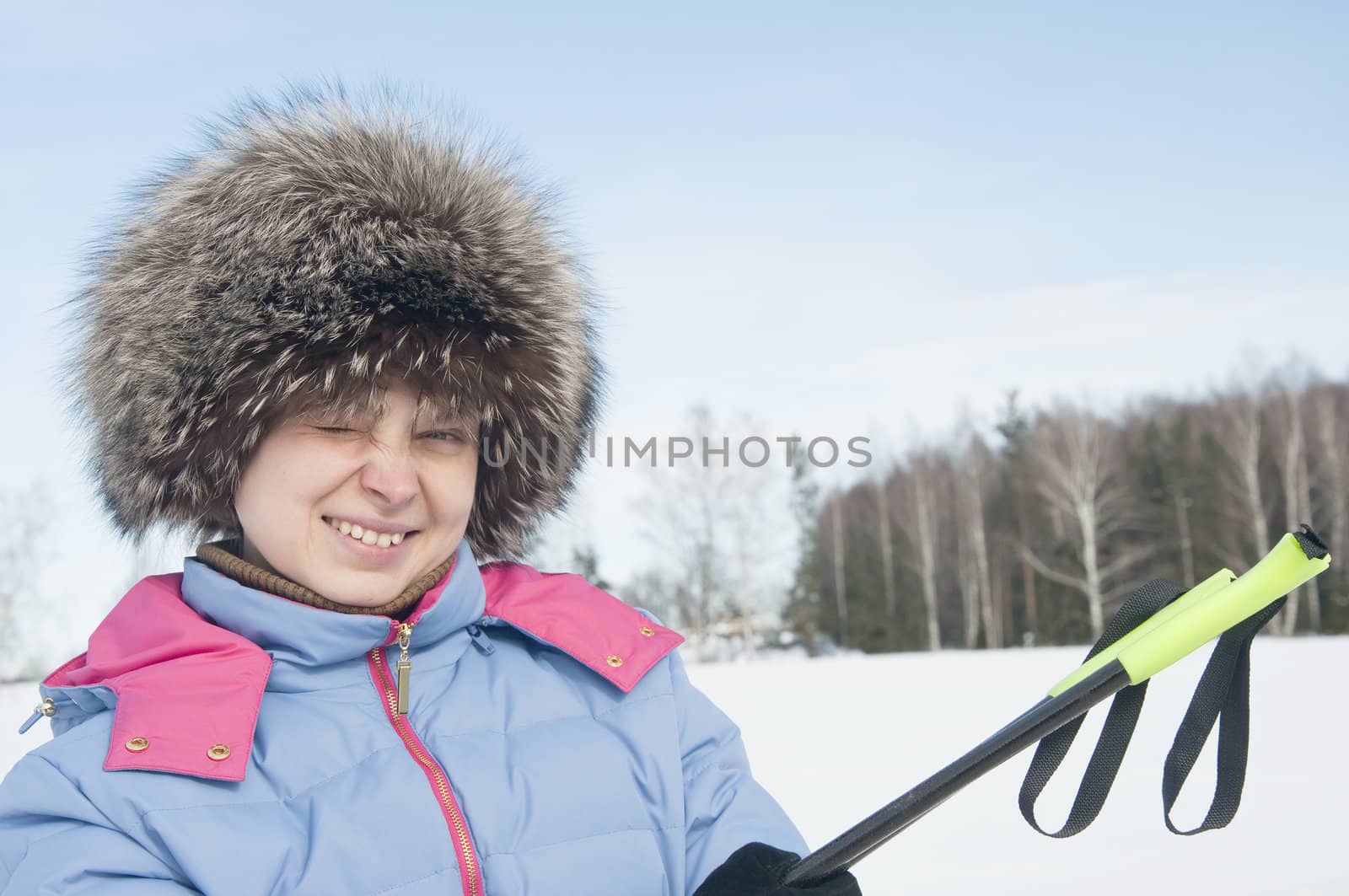 Woman tourist skier in snowy forest with ski poles