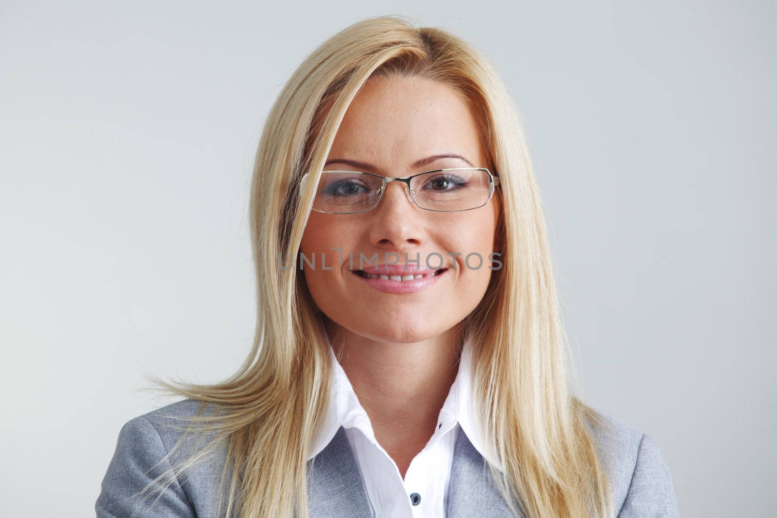 business woman in glasses on gray background