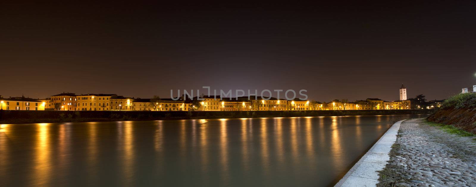Night view of Adige River with the bell tower of St. Zeno in Verona Italy
