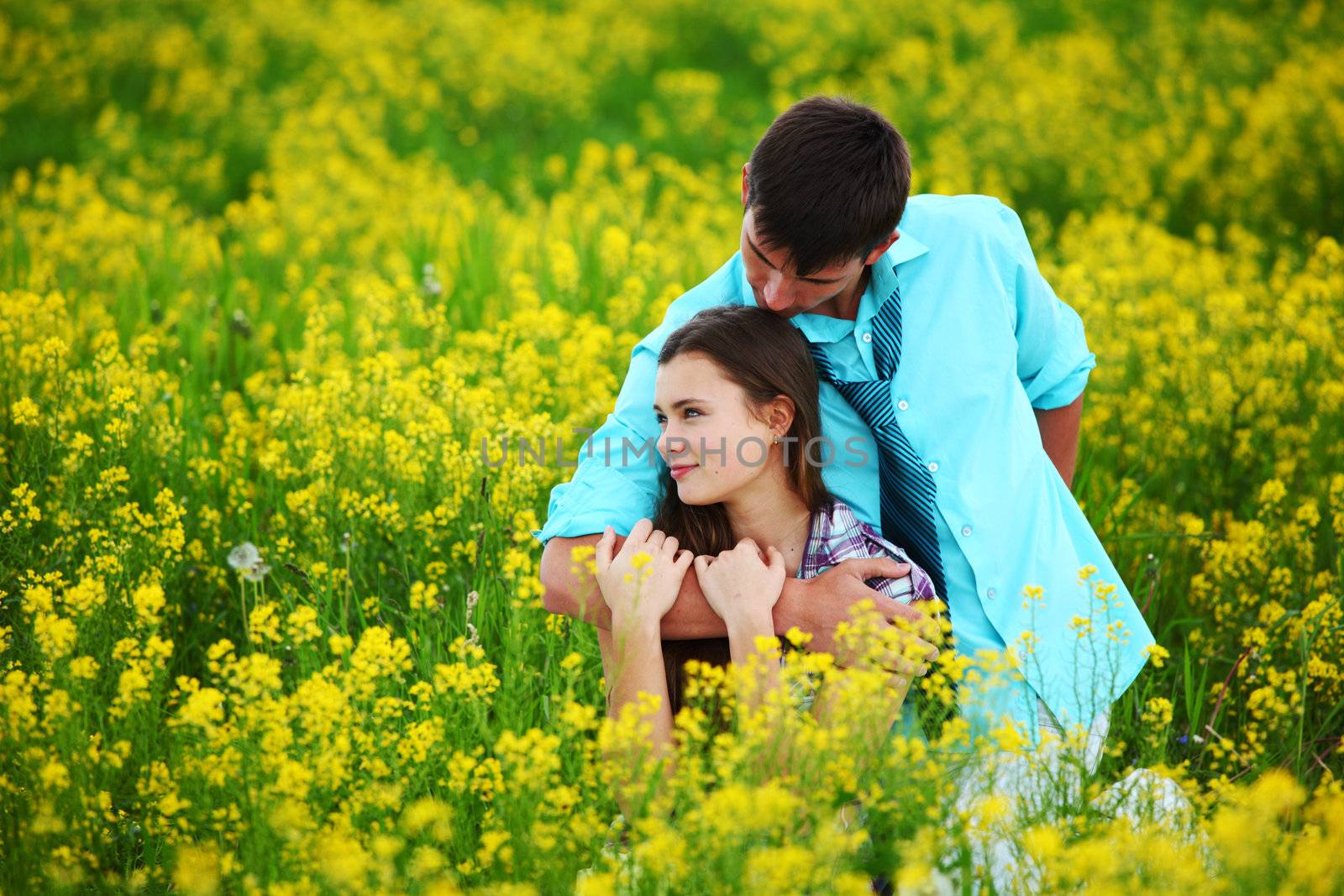 lovers hug on yellow flower field