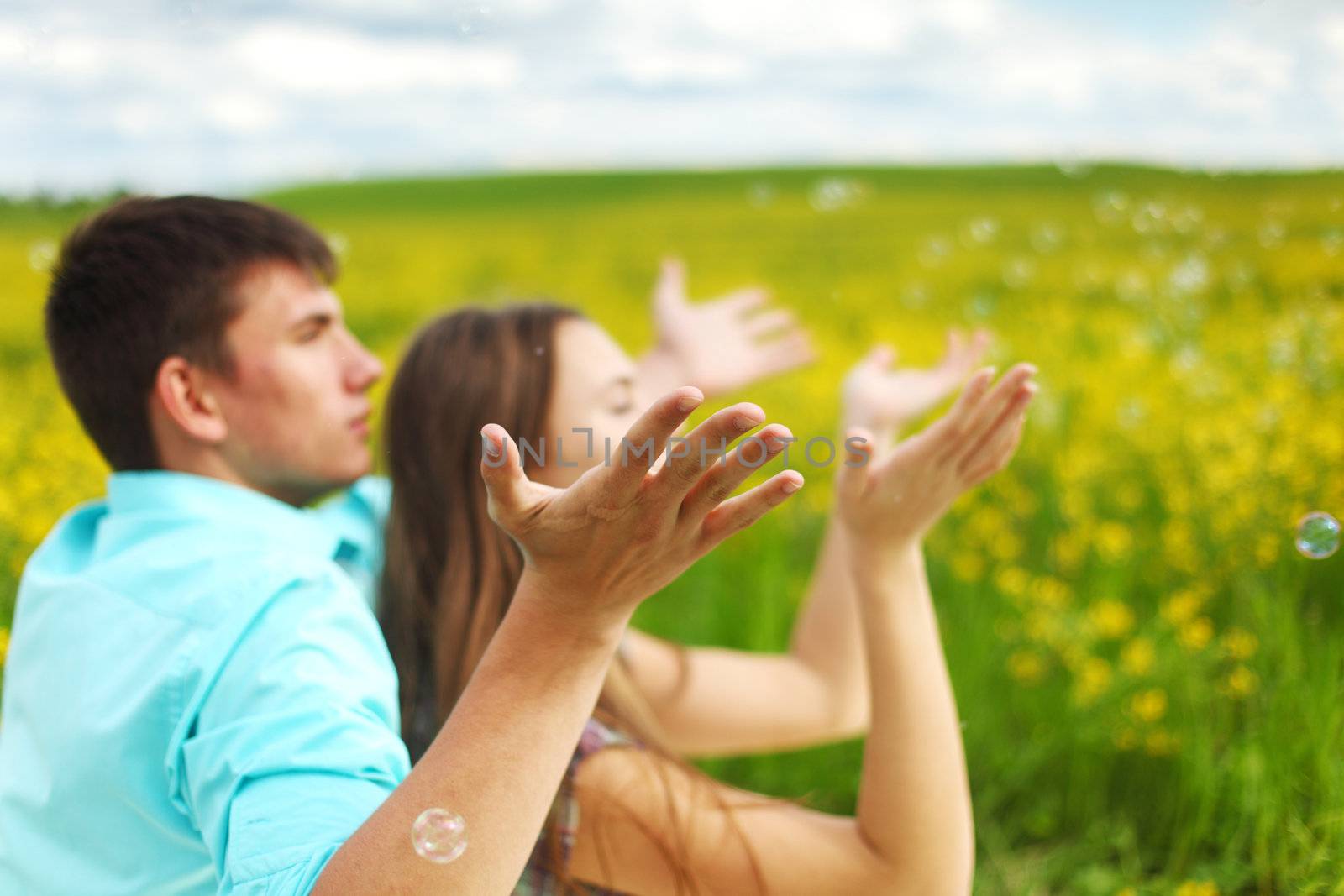 lovers hug on yellow flower field