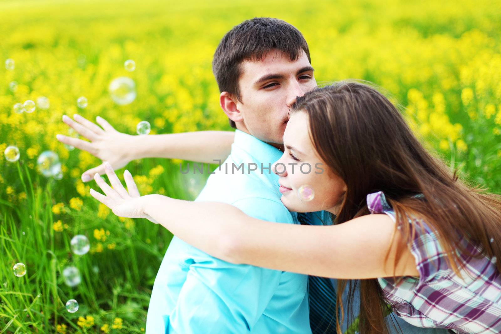 lovers hug on yellow flower field