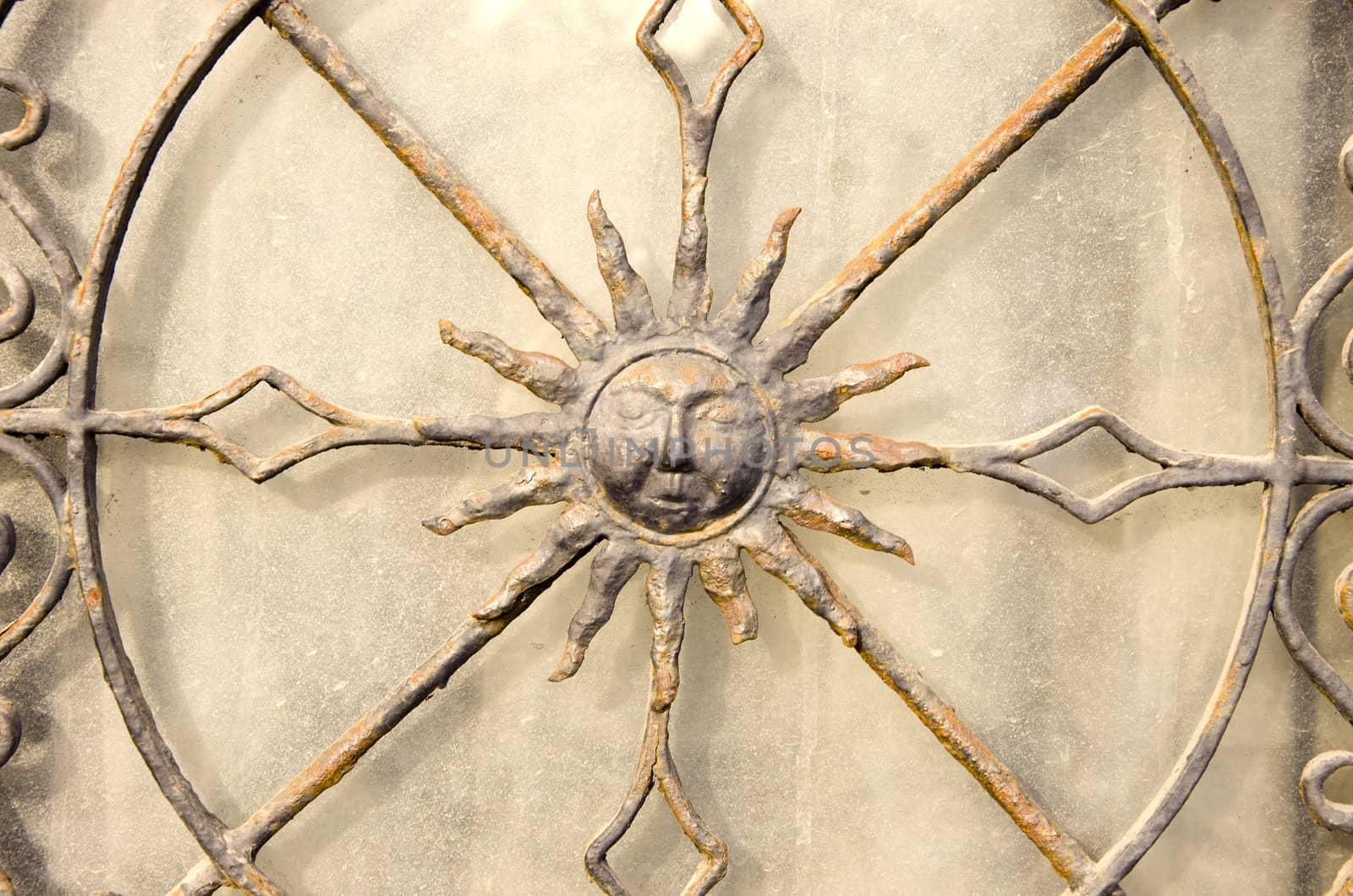 Closeup of decorative metal gate. Sun in middle. by sauletas