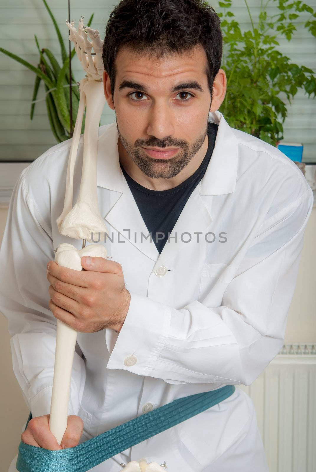 Manual, physio and kinesio therapy techniques performed by a male physiotherapist on a training plastic spine and a female patient