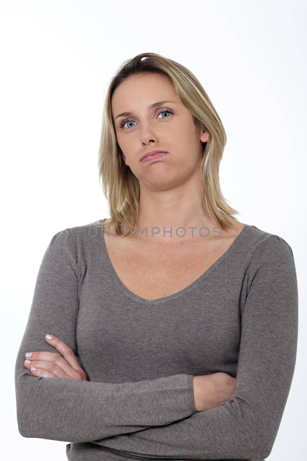 overworked woman in studio with crossed arms