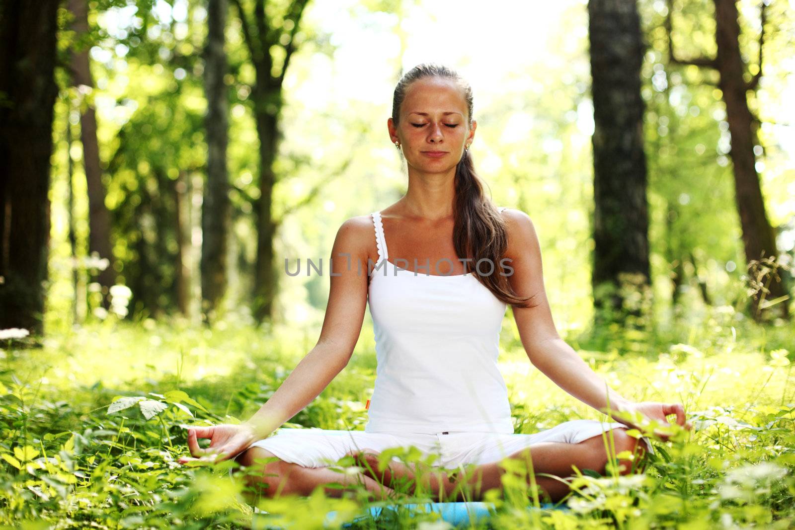 yoga woman on green grass in forest