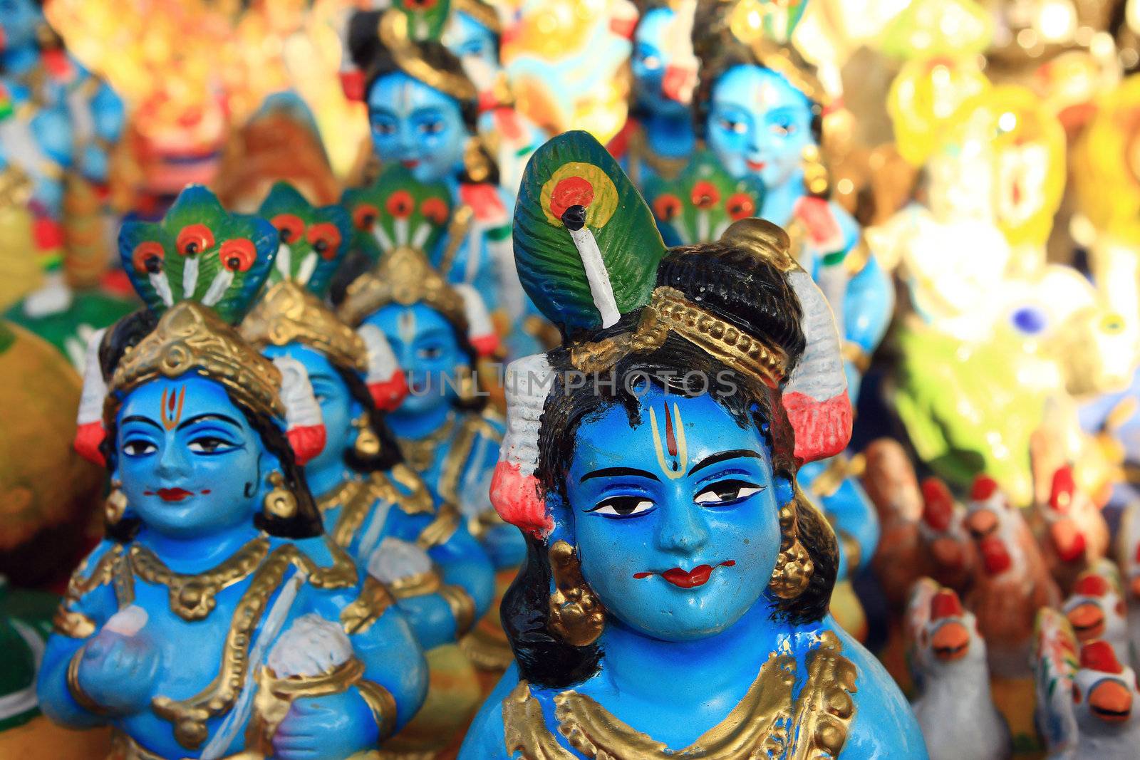 Religious figure of Krishna in Indian street market by cococinema