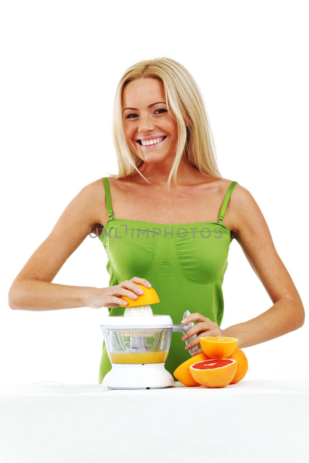 woman squeezes juice by juicer