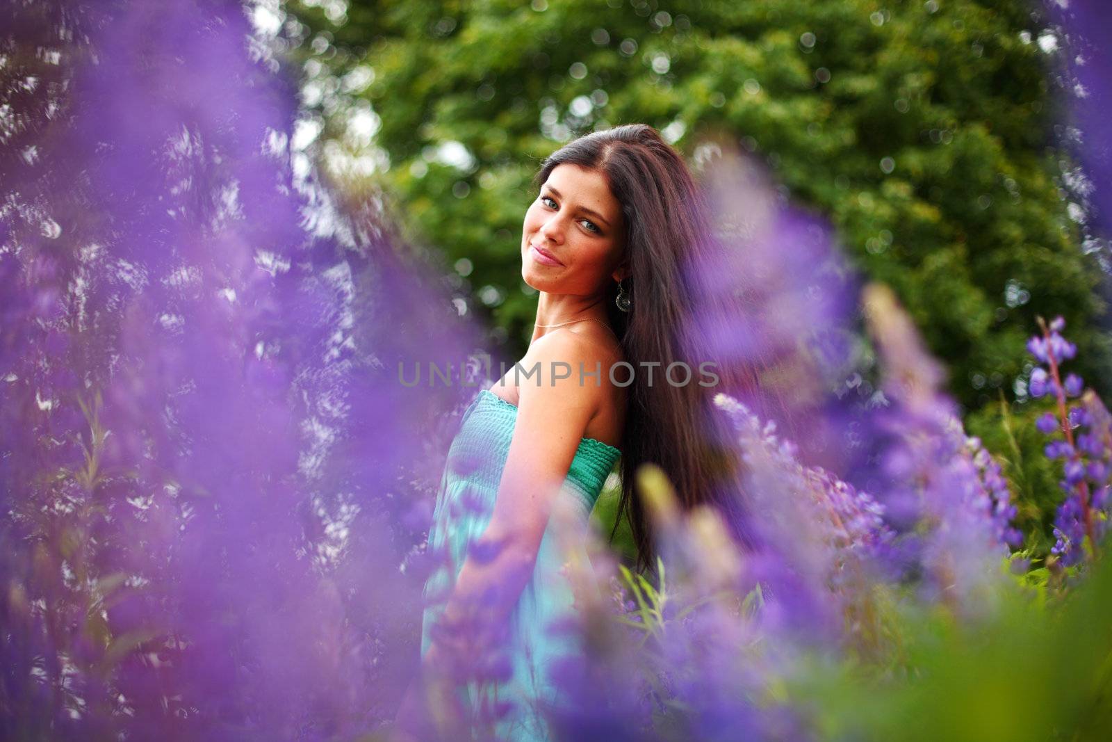 woman on pink flower field close portrait
