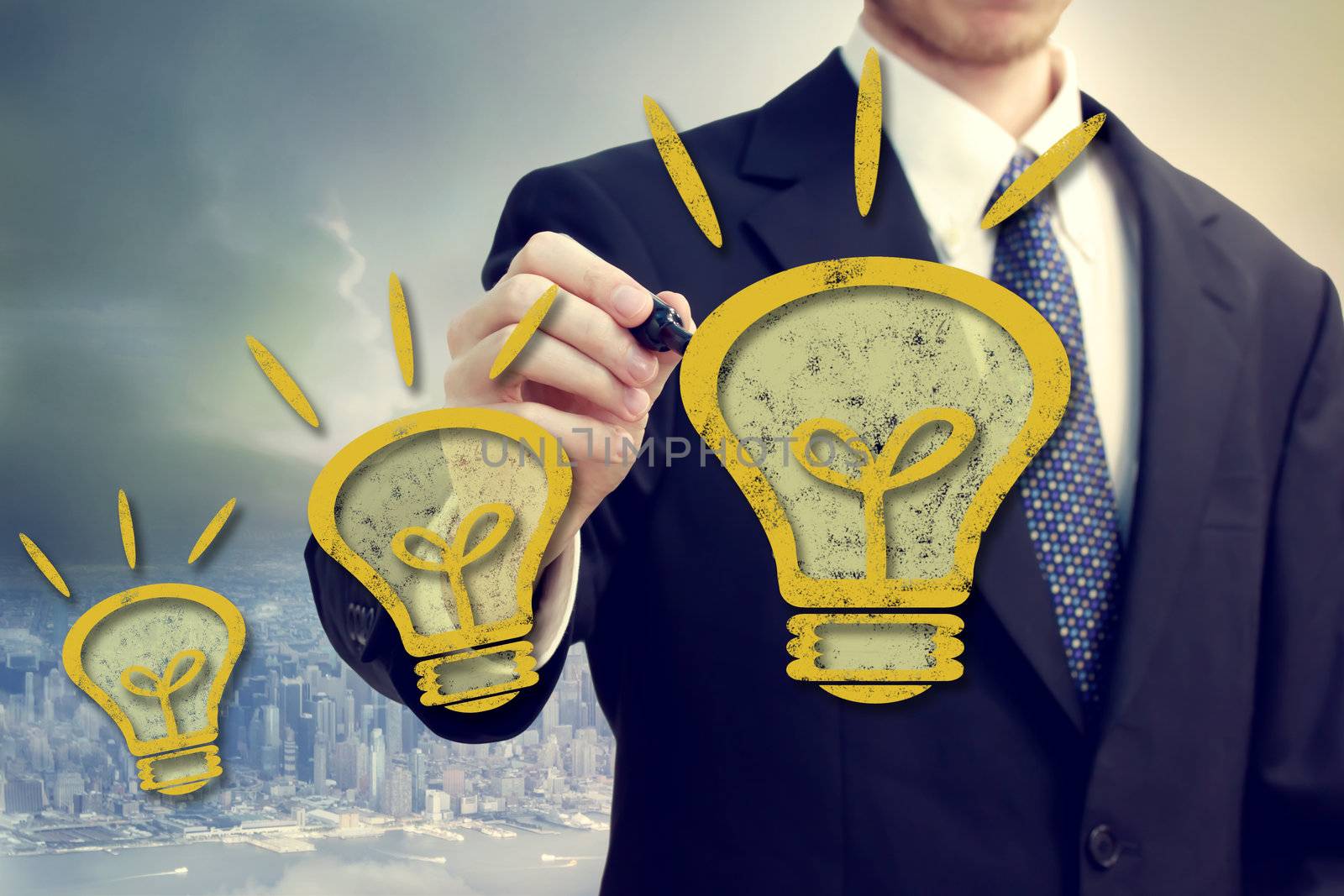 Businessman with yellow idea light bulbs above a big city backdrop