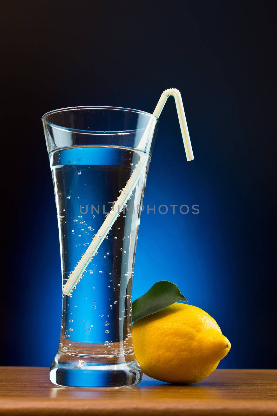 mineral water and lemon on a colored background