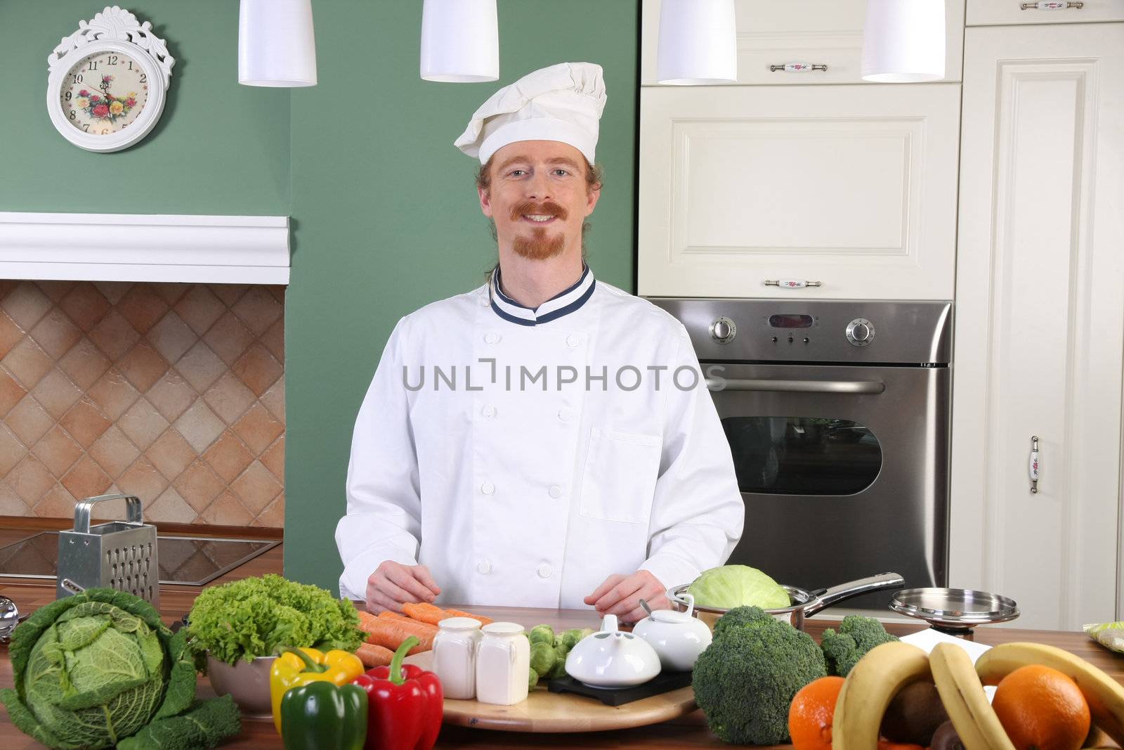 Young chef with vegetables, preparing lunch in kitchen