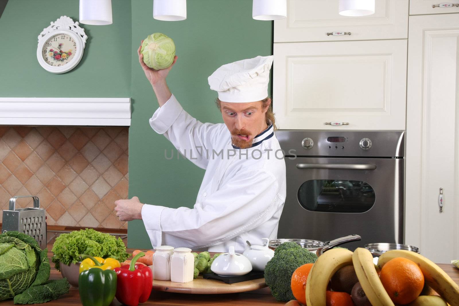 Young chef with cabbage, preparing lunch in kitchen