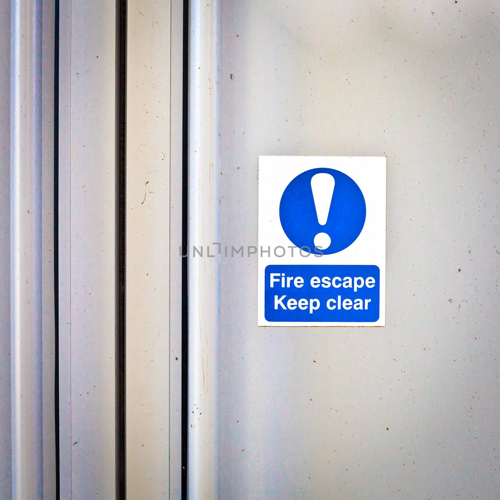 Fire escape sign on a modern door panel