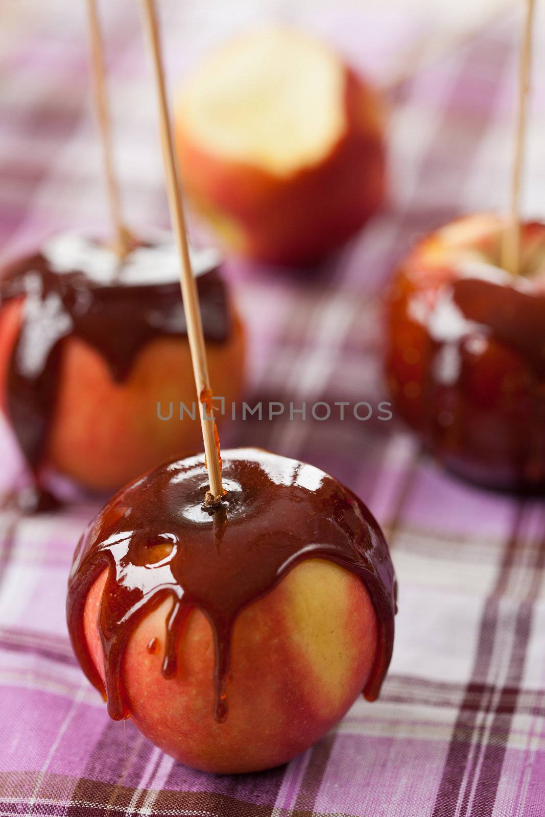 Delicious apples coated with caramelized sugar on a stick